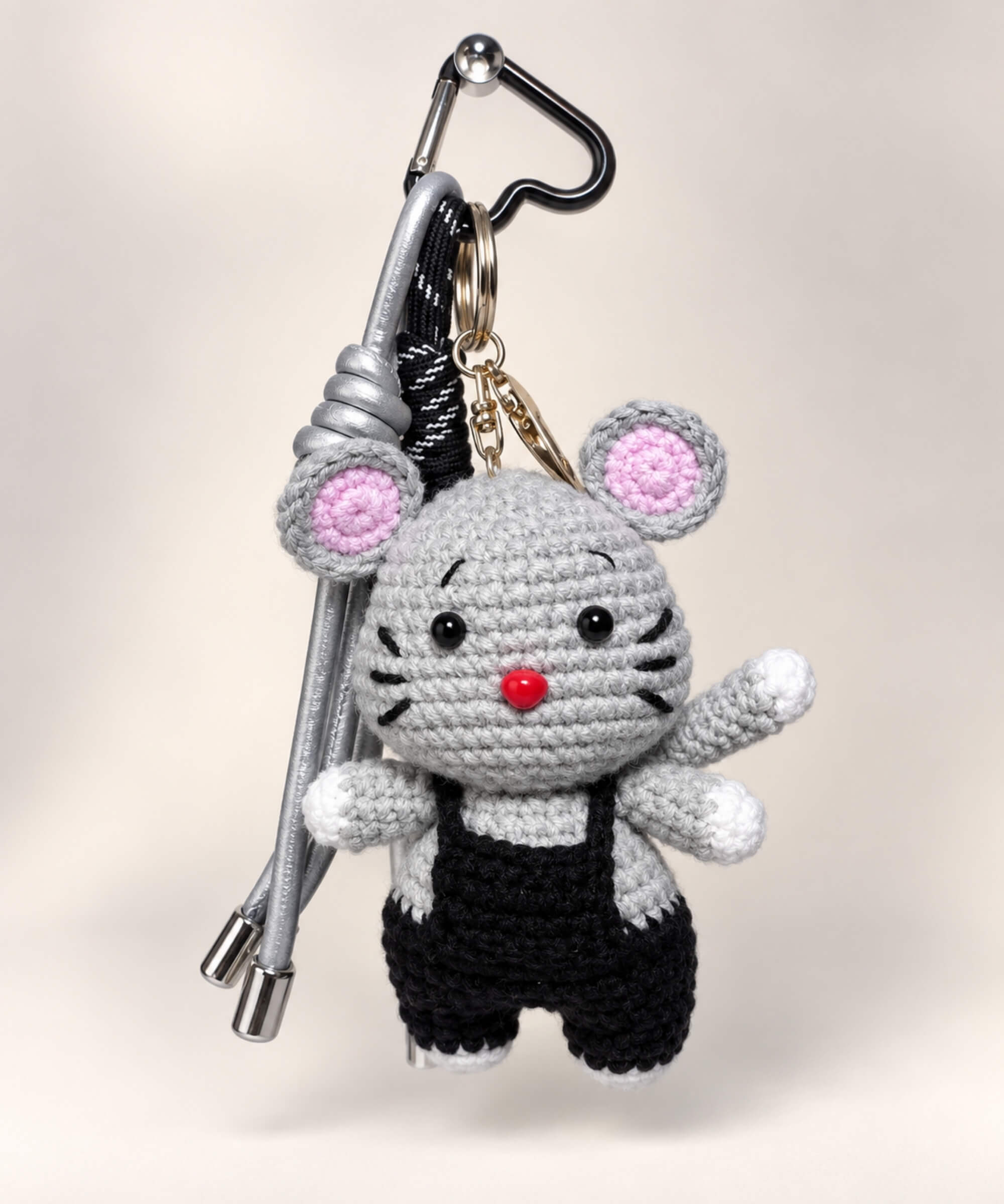 Grey mouse crochet keychain wearing black overalls with black and silver hanging cords